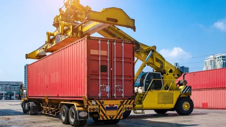 Forklift handling a sea container.