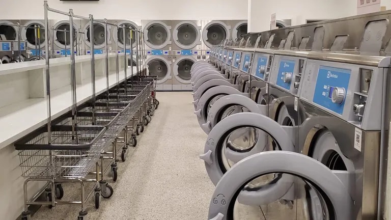 A row of washers in a laundromat
