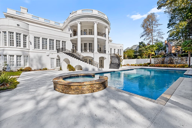 Luxury swimming pool and spa with curved staircase at the Atlanta White House estate on 2.67 acres in Atlanta, Georgia