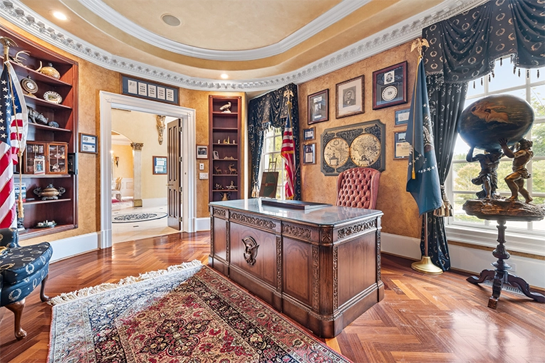 Oval office interior of the Atlanta White House mansion with ornate ceiling, presidential desk, and American flags in Atlanta, Georgia.
