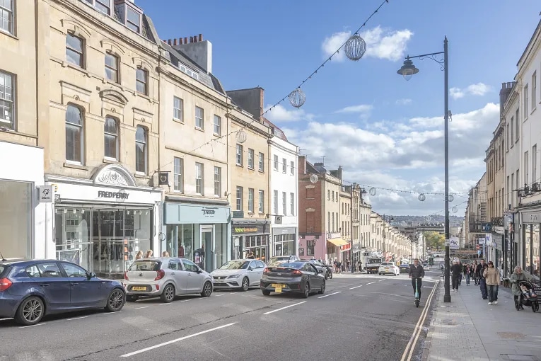 Street-level view of Park Street in central Bristol, showing retail shops, pedestrians, and historic buildings representative of UK commercial leasehold and freehold properties.