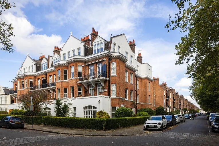 Corner view of a traditional red-brick residential block in Putney, London, illustrating UK freehold and leasehold property types relevant to commercial ownership structures.